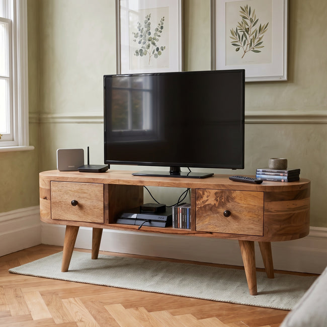 Mini rounded solid mango wood entertainment unit with two drawers shown in a styled room