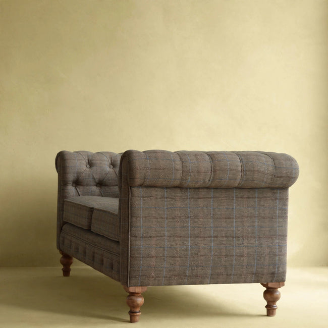 Front view of a multi tweed 2 seater Chesterfield sofa styled in a living room