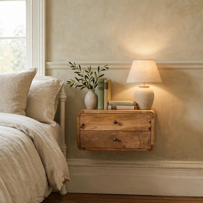 Oak-ish two-drawer floating bedside table mounted on a bedroom wall