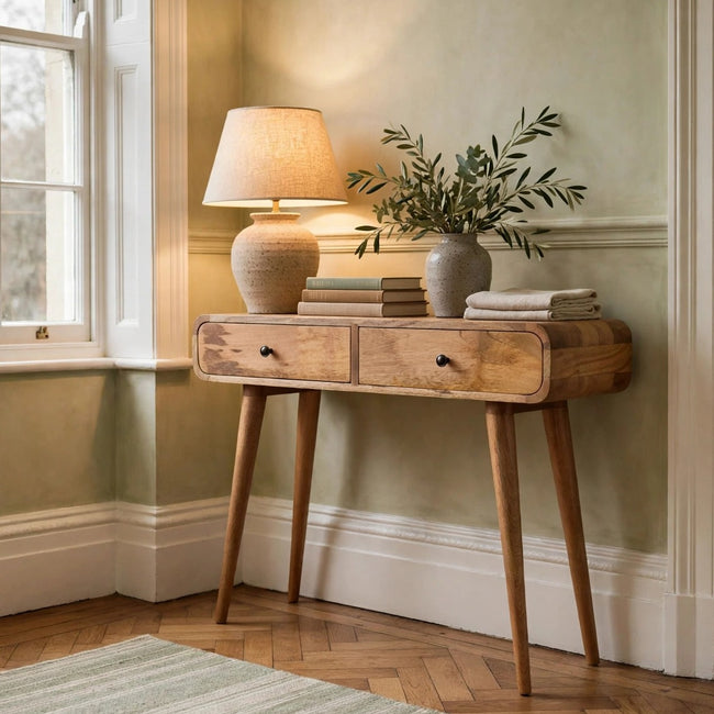 Curved oak-ish solid mango wood console table in a hallway setting