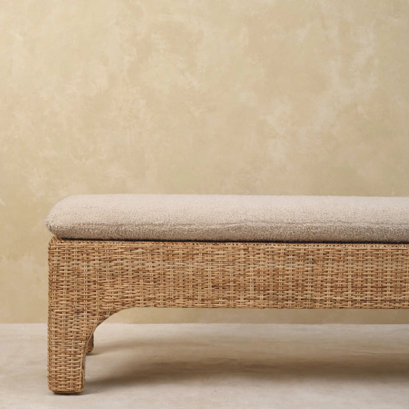 Close view of the Rattan Harmony bench frame and seat cushion in a room