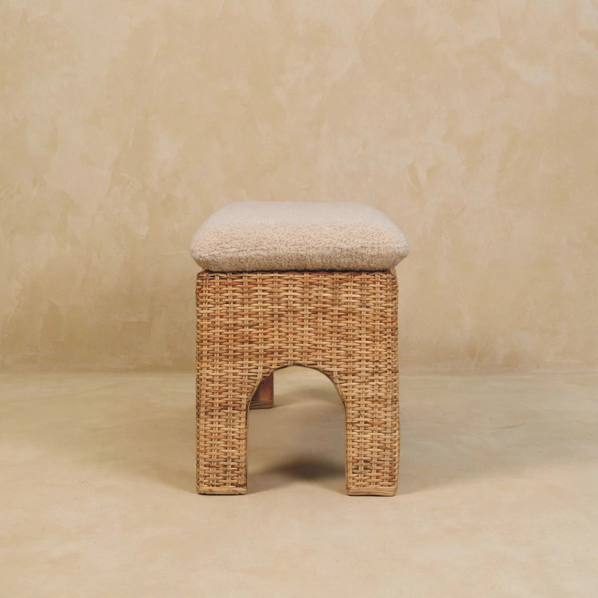Cushioned seat and woven rattan of the Rattan Harmony bench up close