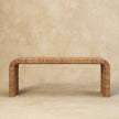Rattan weave bench with warm oak-style finish seen from the front in a room