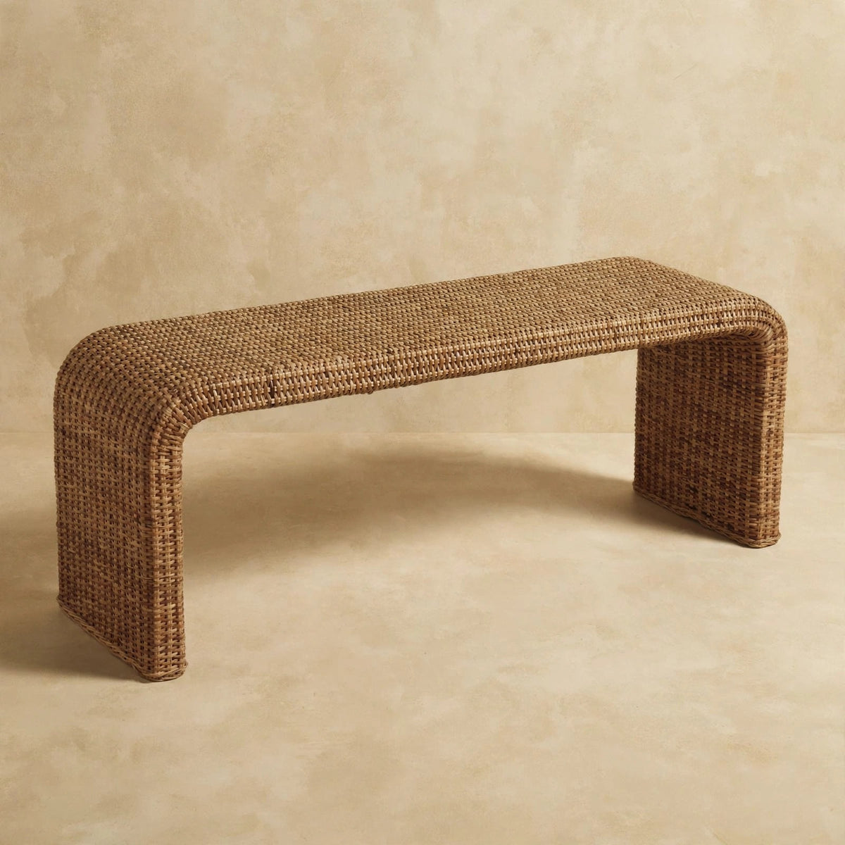 Rattan weave bench with soft curves and earthy tones in a styled room