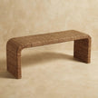 Rattan weave bench with soft curves and earthy tones in a styled room