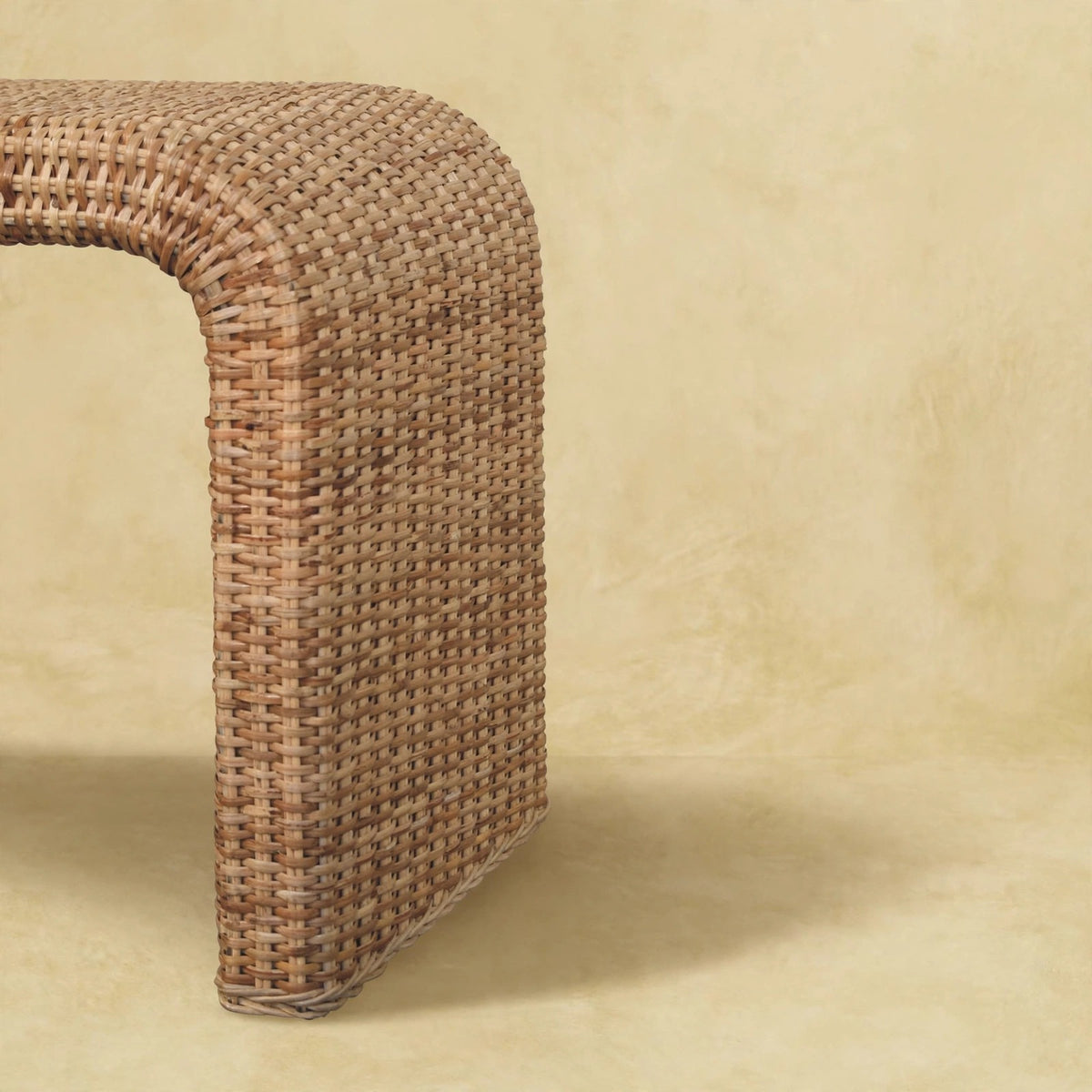 Angled view of the rattan weave bench showing its clean-lined shape