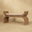 Rattan weave boucle bench placed in a hallway with decor around it