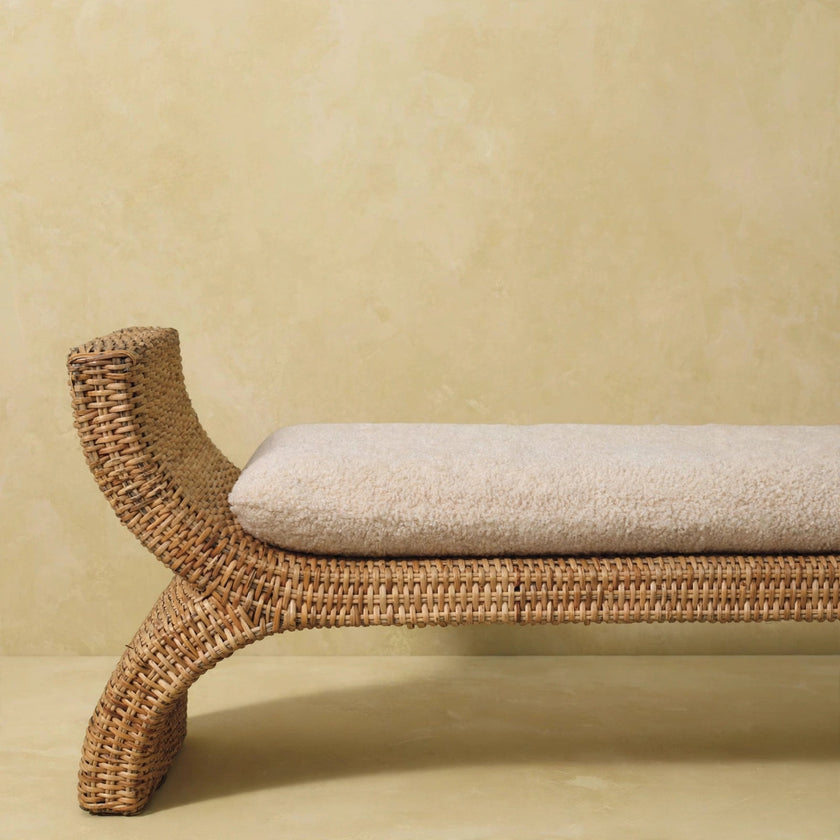Angled view of the oakish mango wood bench with a boucle cushion