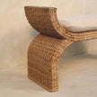 Close-up of the rattan weave and boucle cushion on the bench