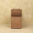 Front view of the boucle bench with woven rattan detail in a room