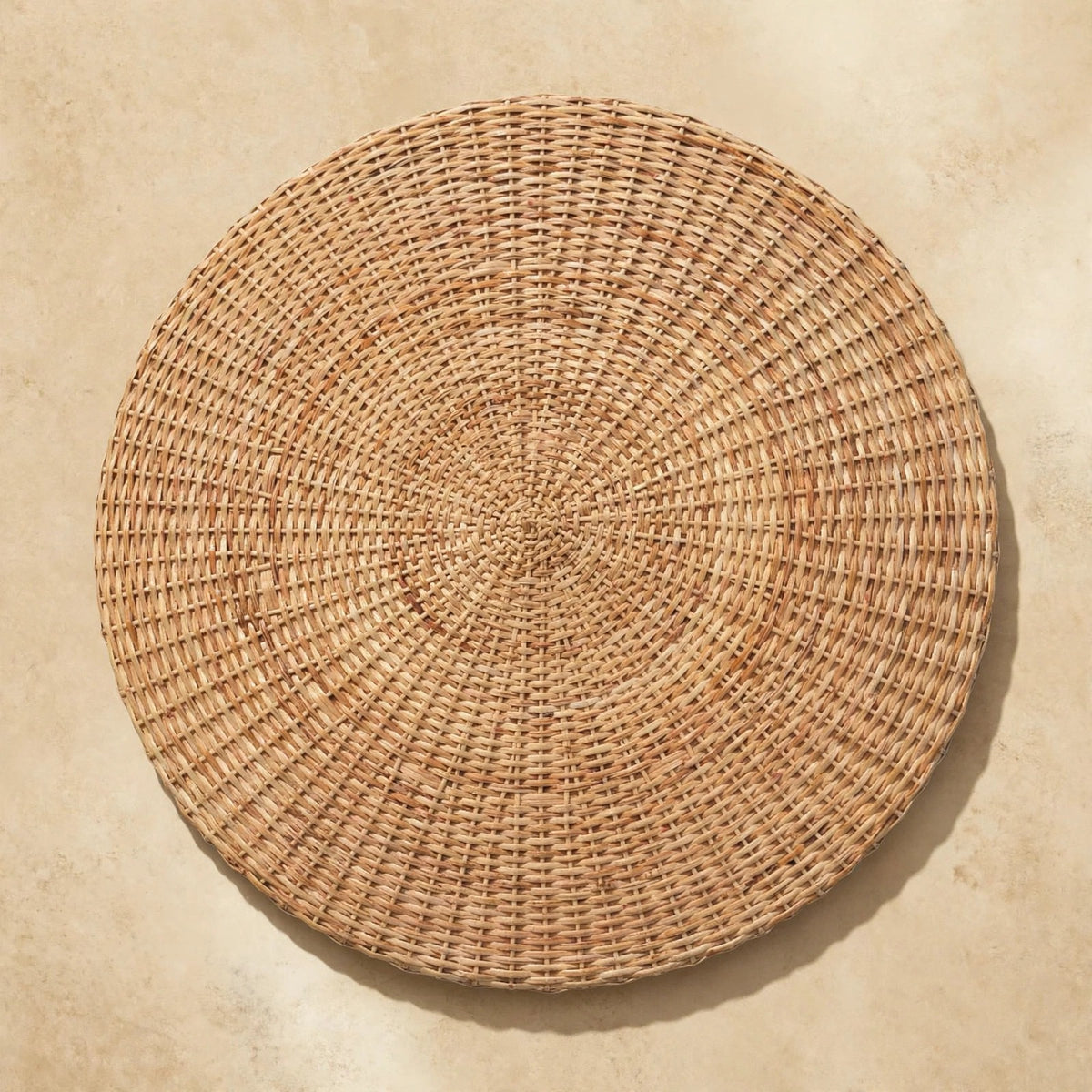 Round woven coffee table as a centerpiece in a styled living space