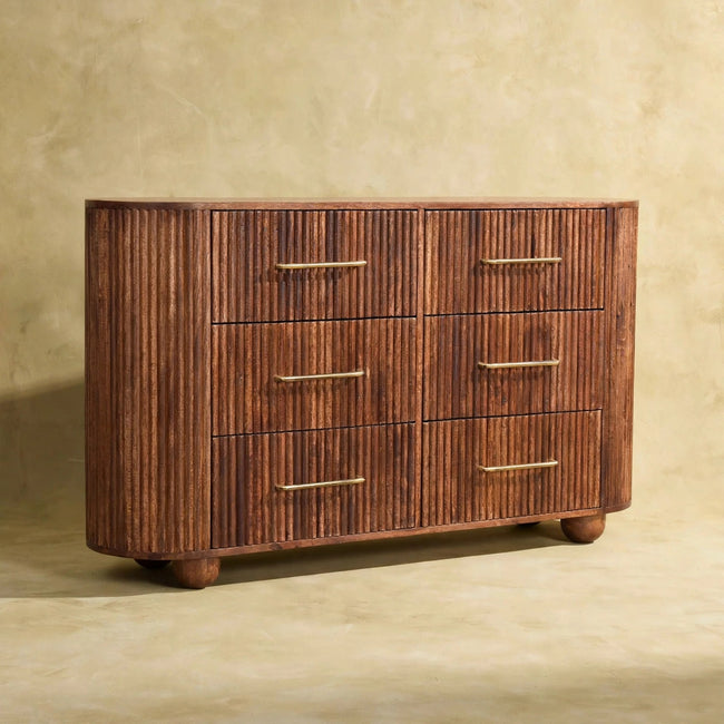 Front view of the Ridgefront chest showing six fluted drawers and antique brass handles