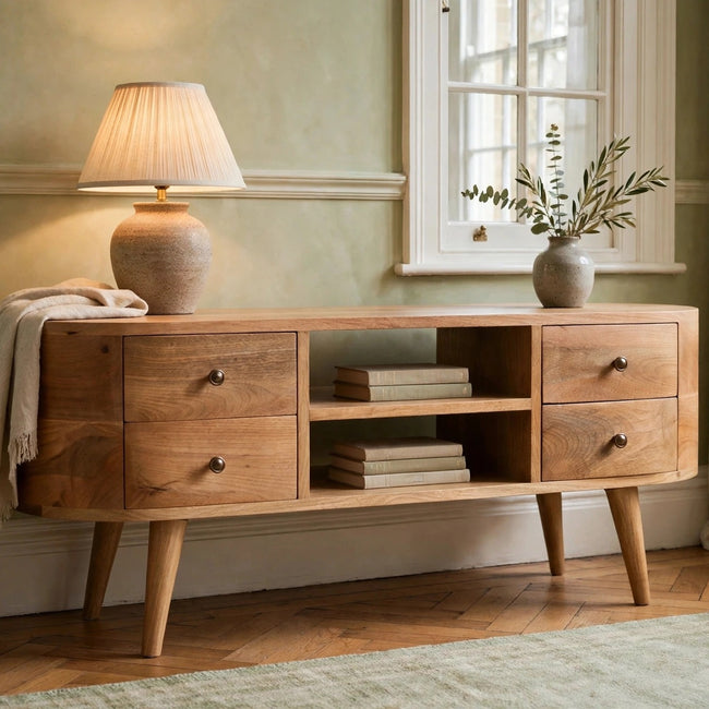 Rounded solid mango wood TV unit with drawers and open slots in a living room