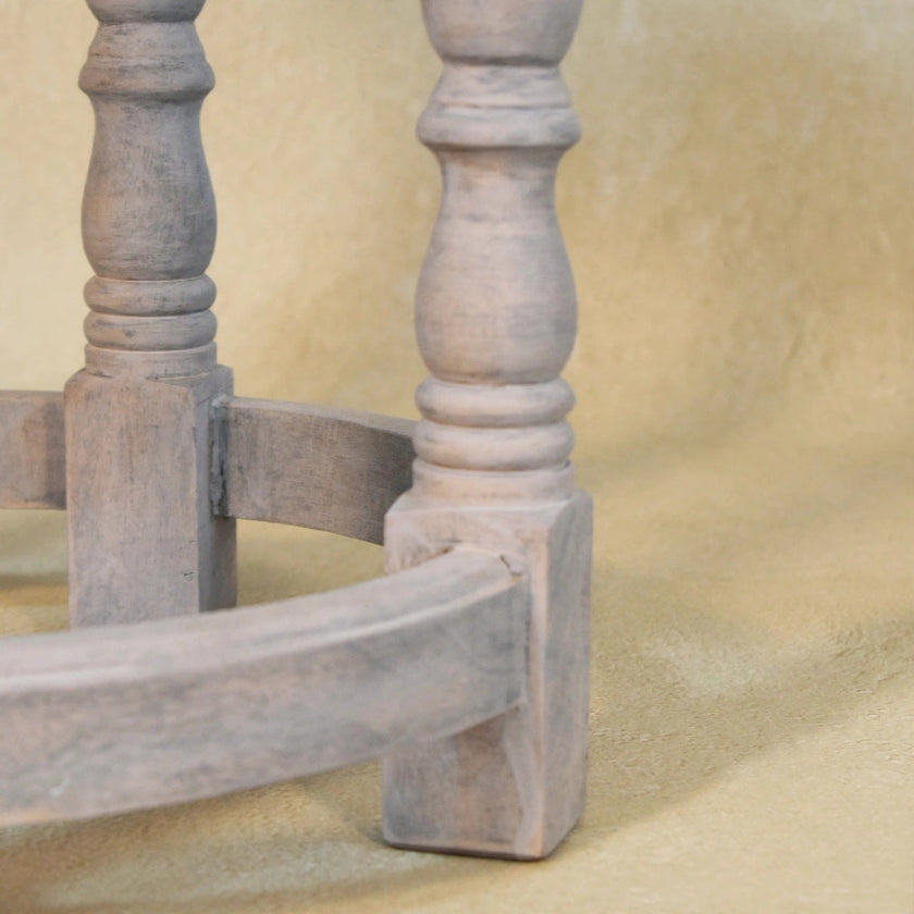 Rustic Charm footstool in a room with turned wood legs and a leather top