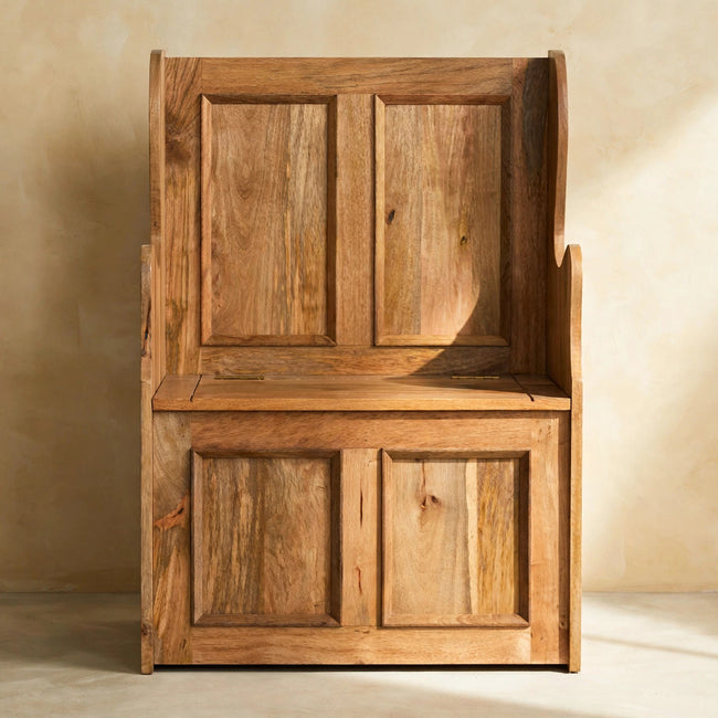 Front view of the Small Monks storage bench showing the carved panel detailing