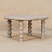 Round Salted Oak coffee table with spindle legs in a living room setting