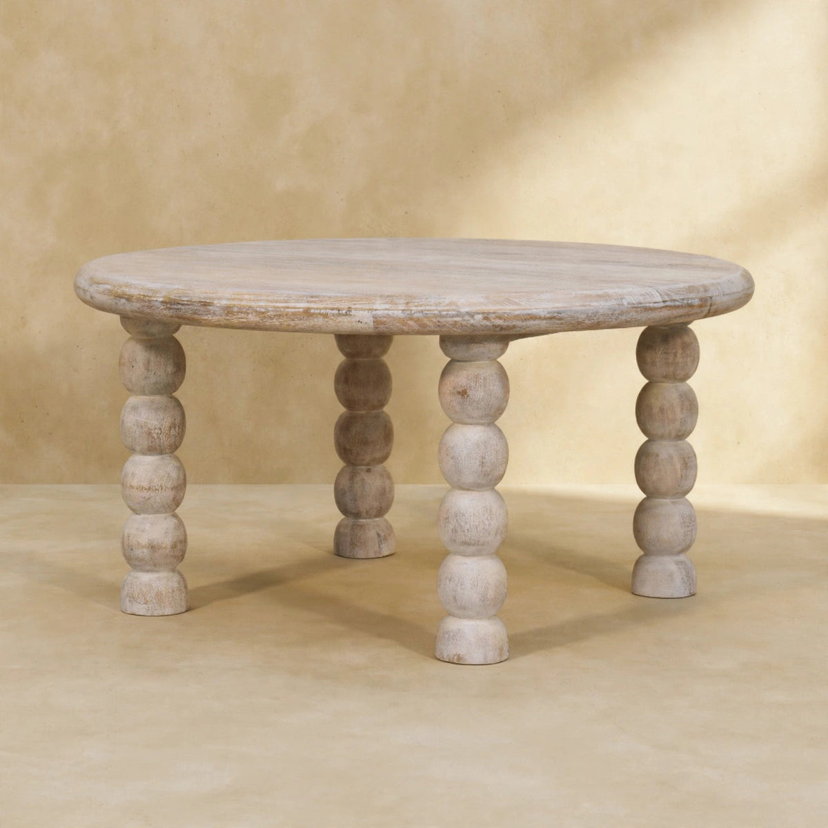 Solid mango wood coffee table in Salted Oak finish beside living room seating