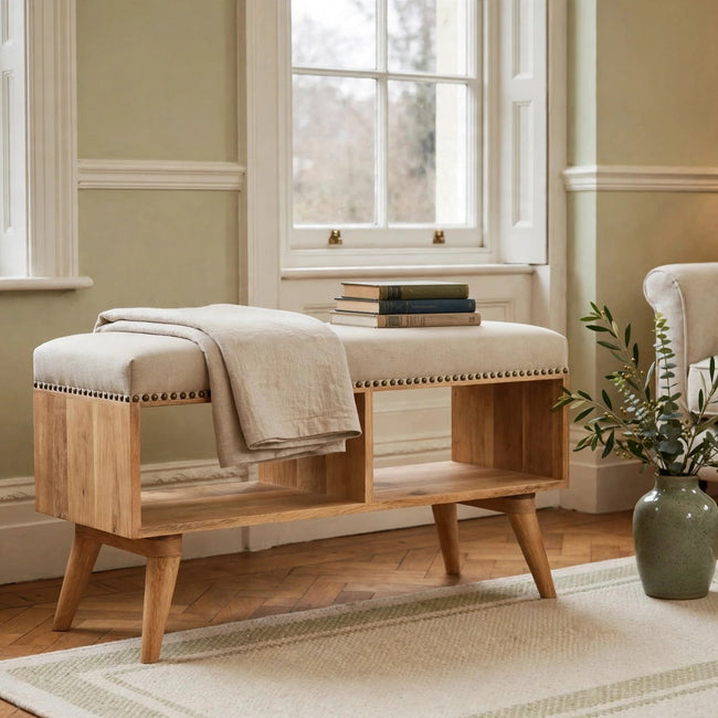 Studded linen open hallway bench with cream upholstery and wooden legs in a styled room