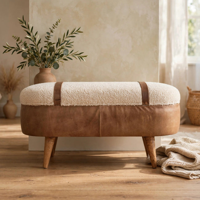 Tan boucle bench with a buffalo leather base styled in a living room