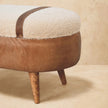 Tan buffalo leather and boucle bench placed in a home interior