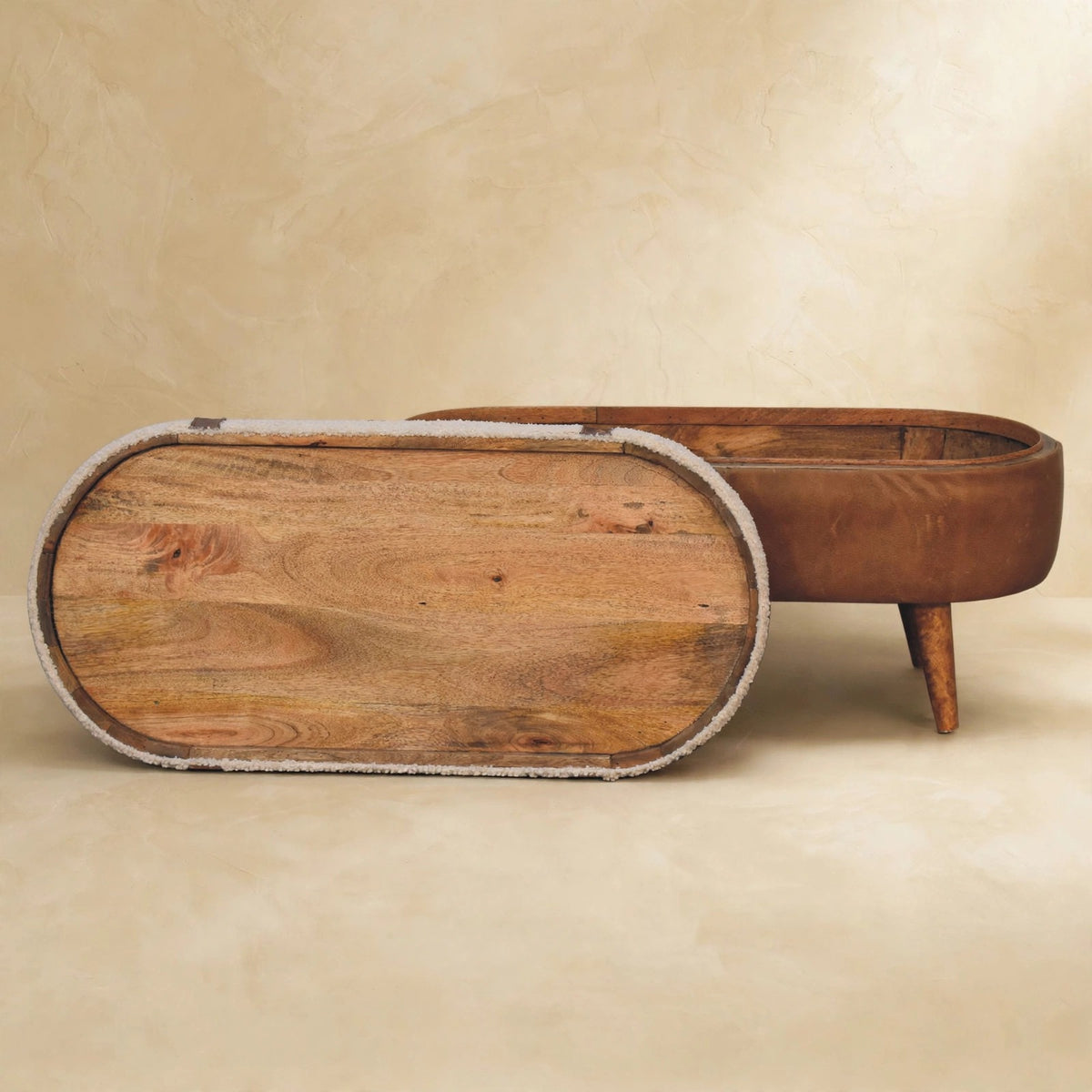 Tan bench with boucle seat and oak-look legs in a styled room