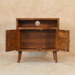 Tova open shelf cabinet styled with decor in a living room