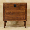 Tova open shelf cabinet in a living room, showing the solid mango wood grain and finish