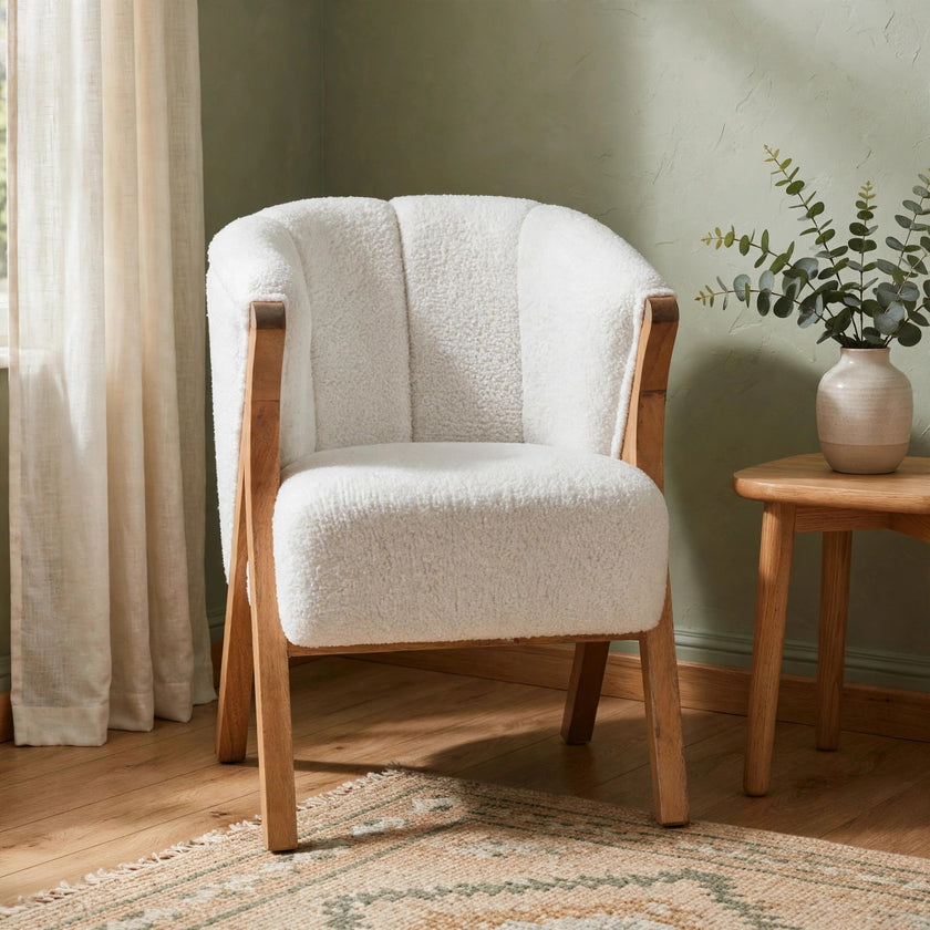 White boucle accent chair with solid mango wood legs shown in a styled room