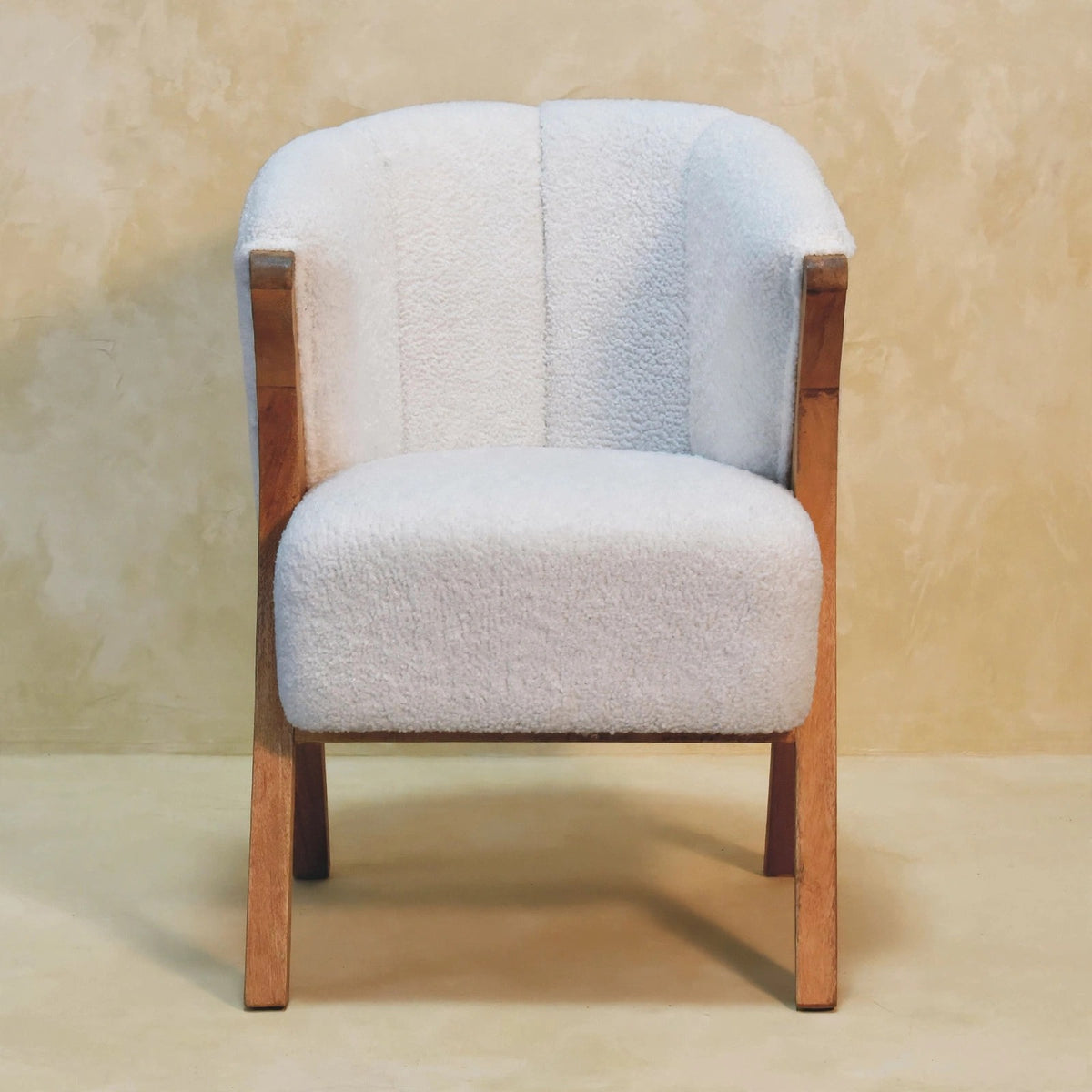Front view of the white boucle minimalistic chair in a room setting