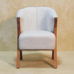 Front view of the white boucle minimalistic chair in a room setting