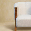 Close view of the textured white boucle upholstery on the chair