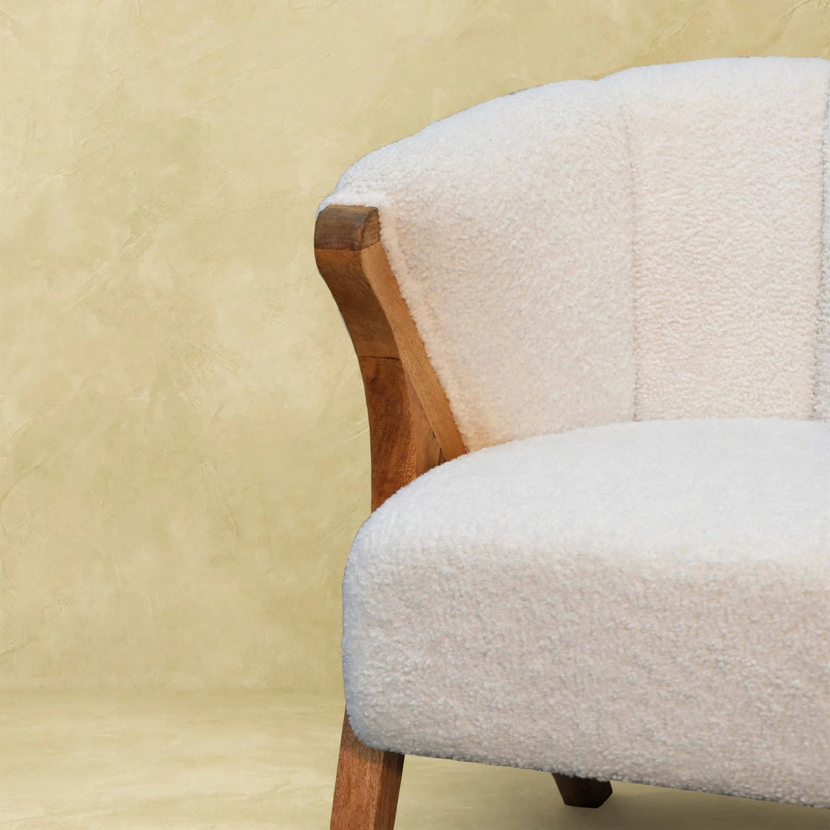 White boucle minimalistic chair styled in a bedroom or study corner