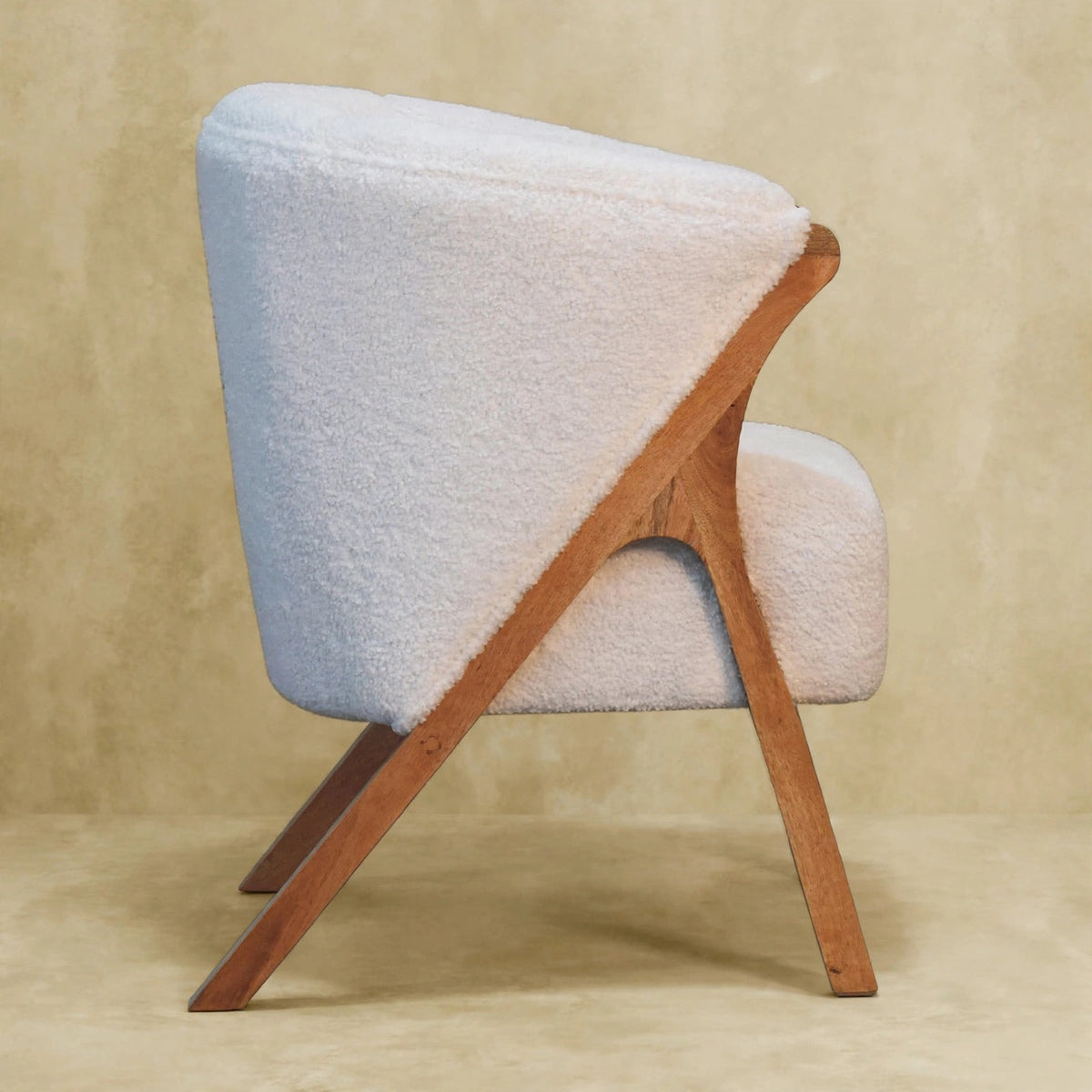 Back and side view of the white boucle chair in a room