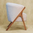 Back and side view of the white boucle chair in a room